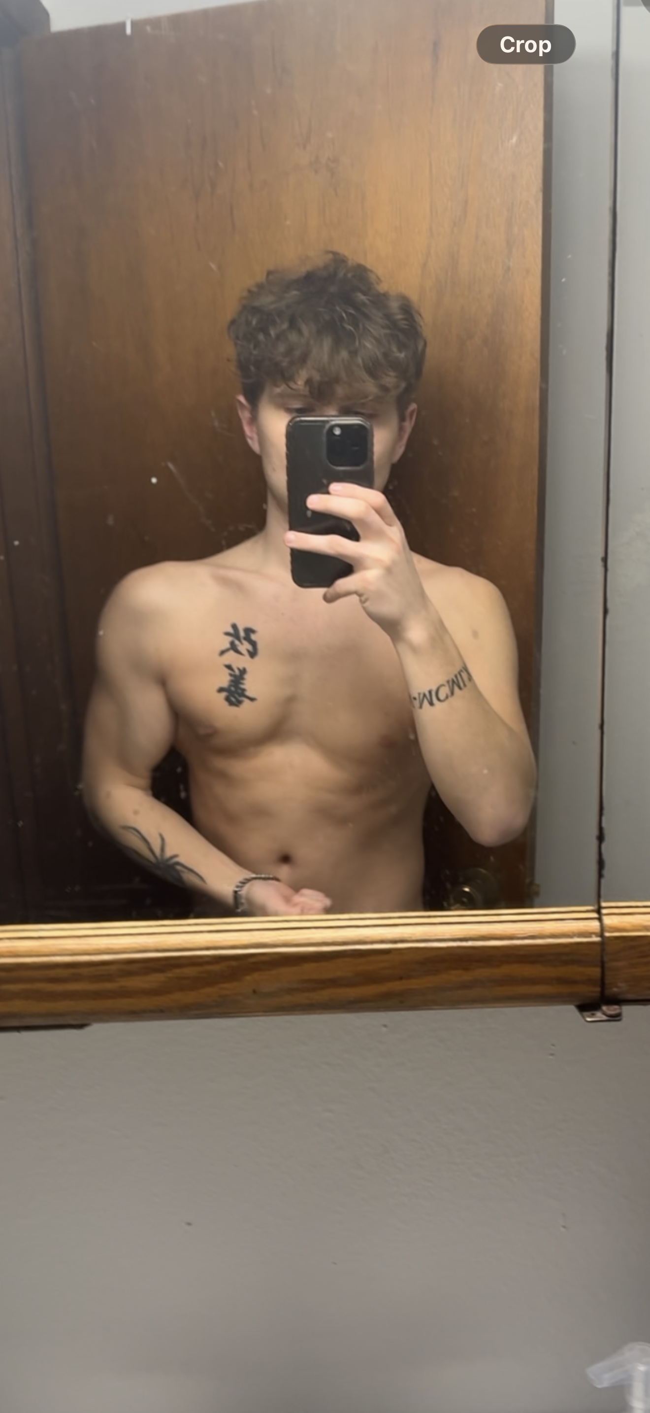 Before photo: mirror selfie in front of a wooden door