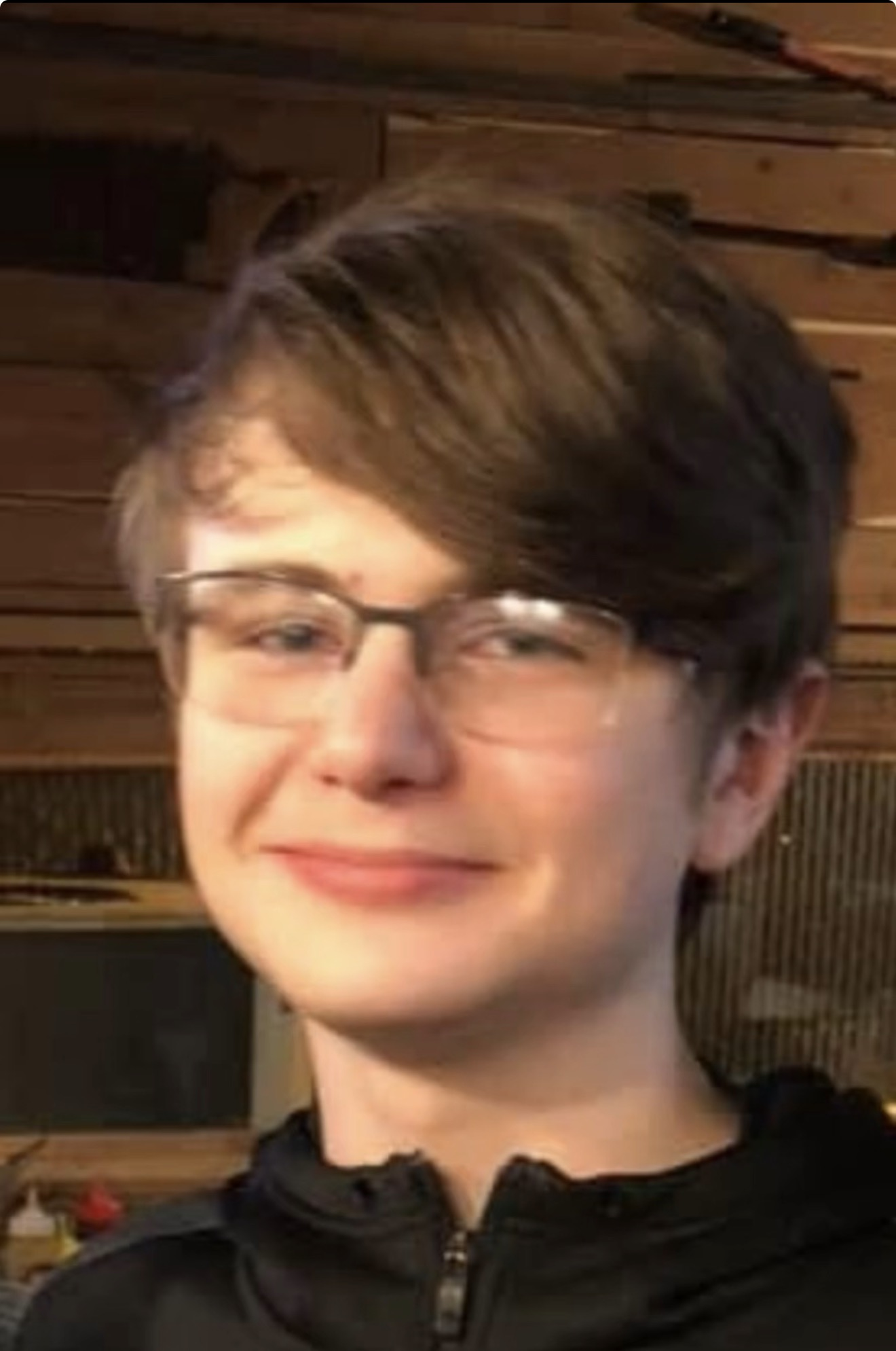 Before photo: portrait wearing glasses and a black zip-up top